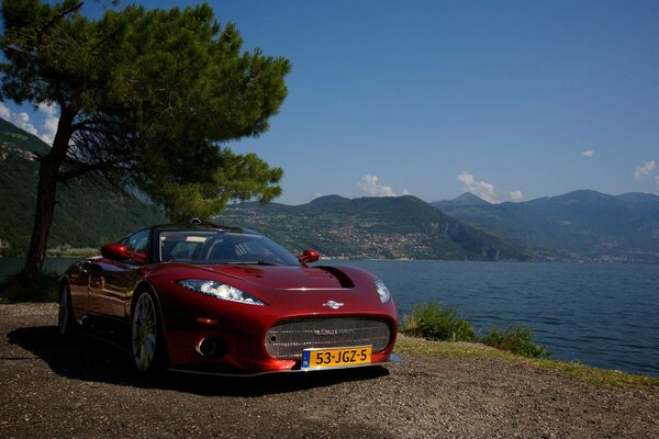 Red expensive car on the shore