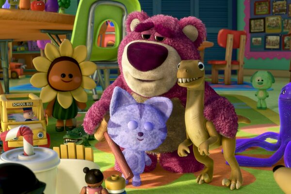 Toy story. Bear hugs dinosaur and cat