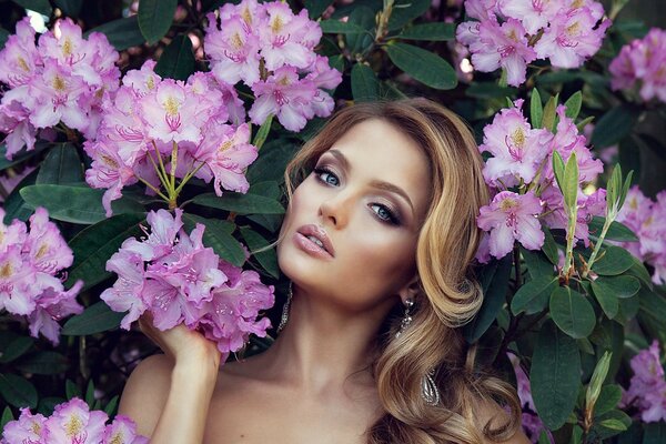 Hermosa chica en el fondo de las flores