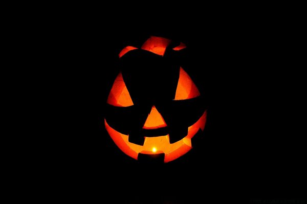 The ominous pumpkin. Glowing pumpkin on a dark background