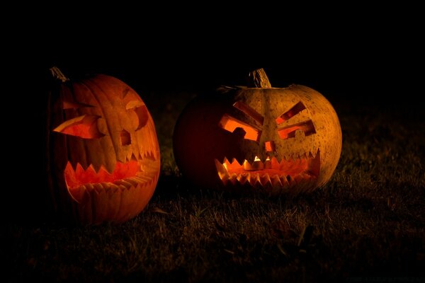 Pumpkins carved for Halloween glowing in the night