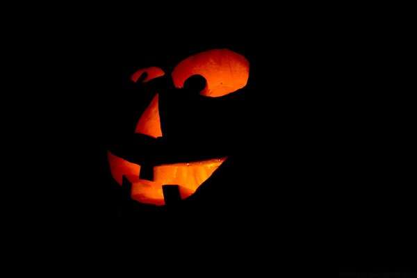 Pumpkin glows with a creepy smile on Halloween