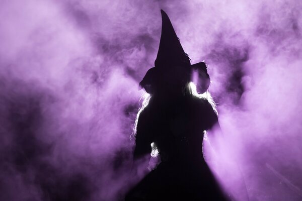 Silhouette of a witch purple smoke