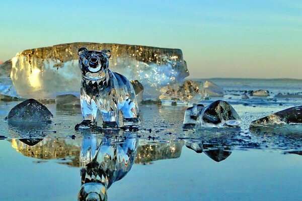 A glass bear on an ice-covered lake