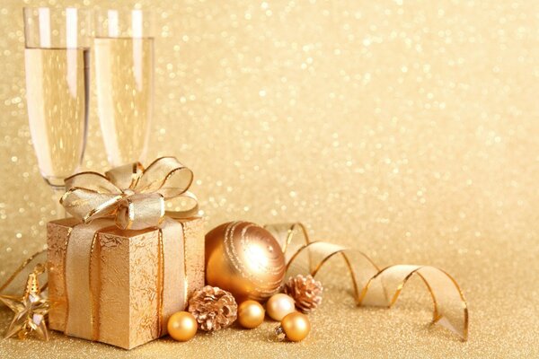 Golden postcard with champagne glasses and gifts