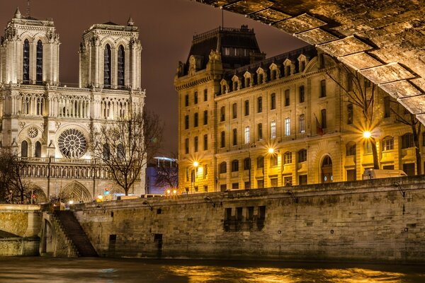 Urban architecture. The ancient church of autumn dawn on the river. Water and leaves