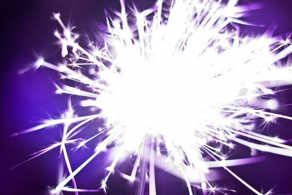 Sparkler close on purple background