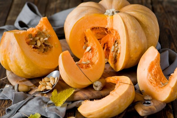 A cut pumpkin on a table in a cloth