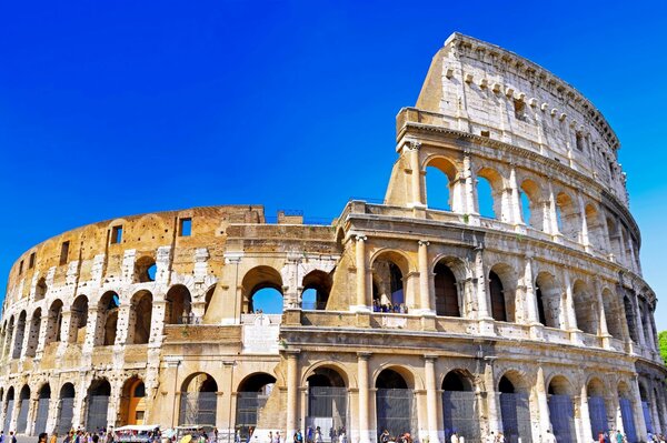 The ancient Colosseum stands on a hill