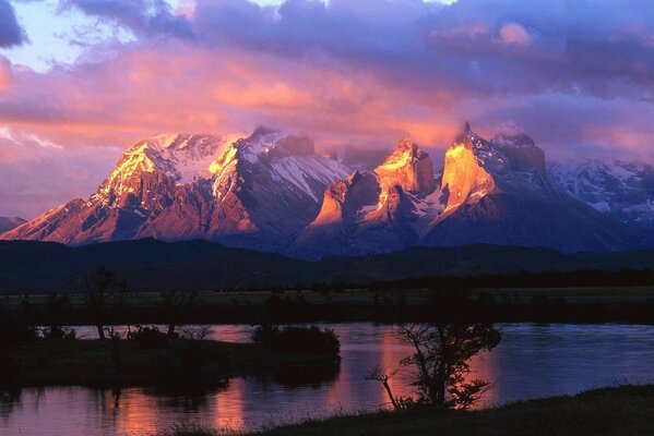 Snowy mountains in the rays of the rising sun