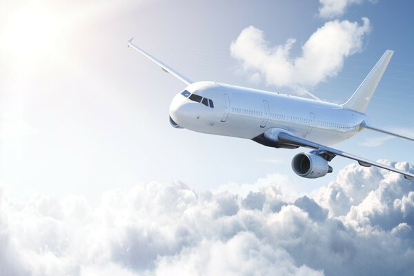 A white plane is flying in the sky above the clouds