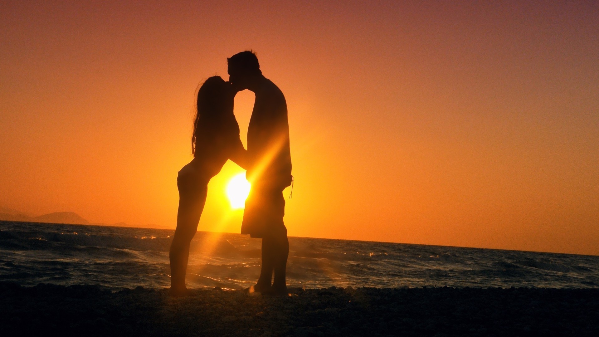 coppie innamorate tramonto alba sole spiaggia crepuscolo acqua sera mare illuminato oceano cielo