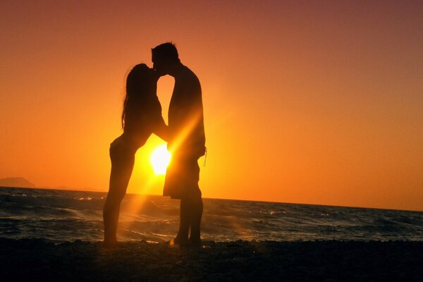 A kiss of two lovers at sunset