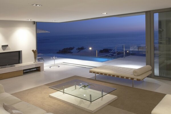 Living room in beige tones with a view of the water