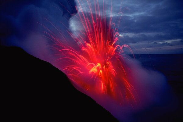 The eruption of lava splashes in smoke