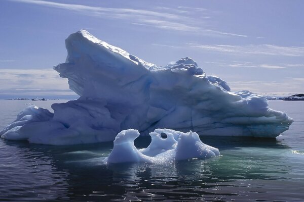 Two icebergs in the middle of the ocean