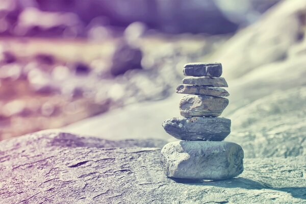 Improvisation stone snowman on a rock