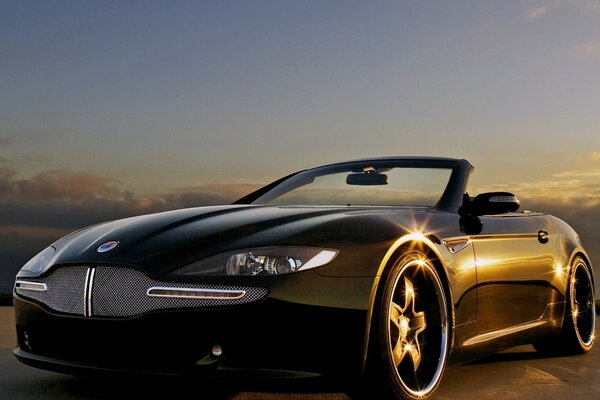 Black convertible on the background of the evening horizon