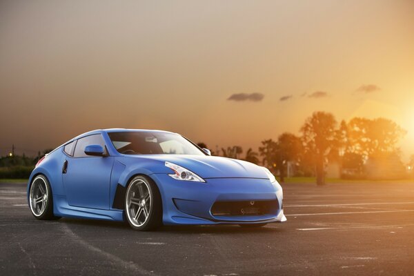 Sports car on sunset background