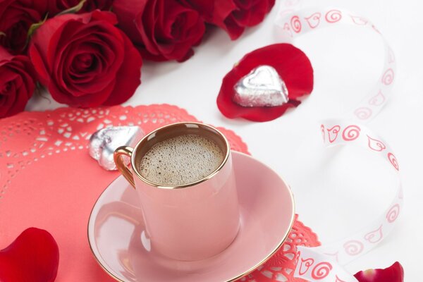 Eine Tasse duftenden Kaffee und ein Strauß Rosen