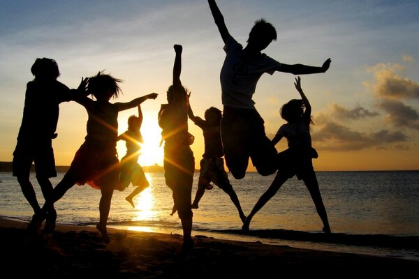 Photos of young people jumping on the beach