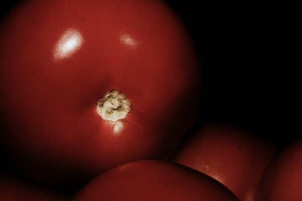 Fruits are red on a black background, taken using macro photography