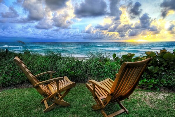 Wooden rocking chairs by the sea