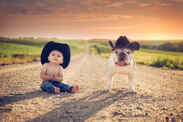 Ein junger Cowboy und sein treuer Hund mit Hüten