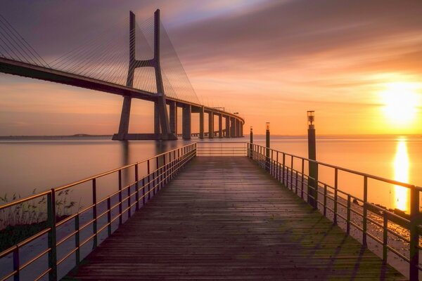 Beautiful sunset on the background of the bridge