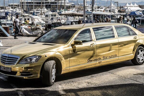 Golden elongated limousine car at the exhibition