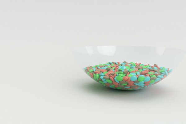 Colored dragees in a transparent dish 3D graphics