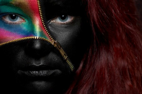 Painted face of a woman with a zipper