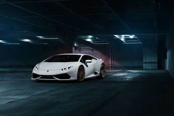 White racing car in an underground parking lot