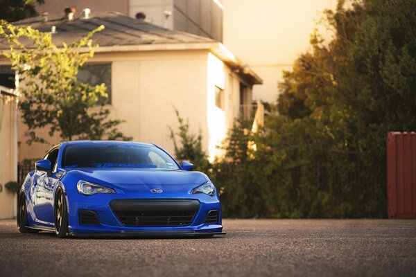 Blue car on the background of a house