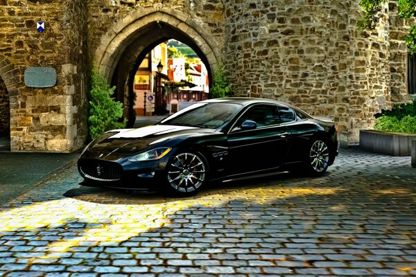 A black car on the sidewalk