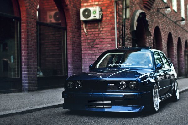 Blue car on the background of brick buildings