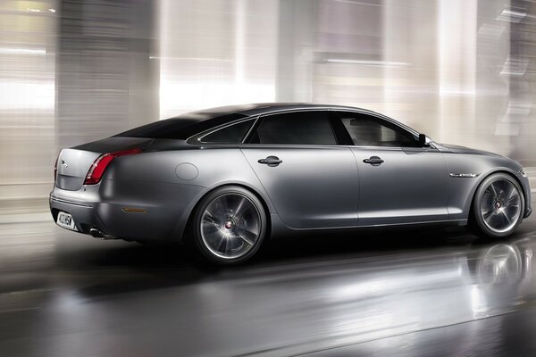 A gray car on a gray asphalt background