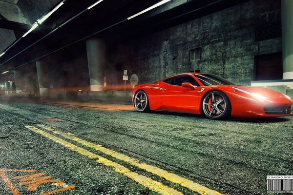 A red Ferrari is driving on the road