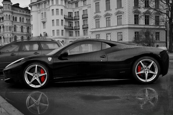 Black and white photo of a car on a city street