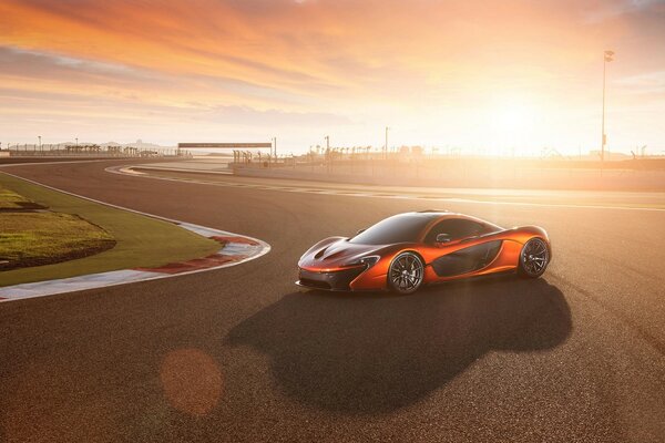 Orange sports car at sunset