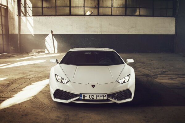 A car in a white Lombargini garage