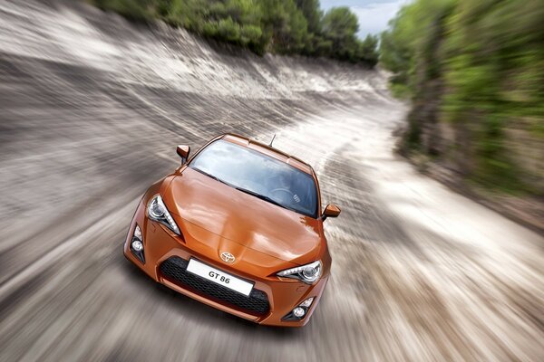 Orange car at fast speed