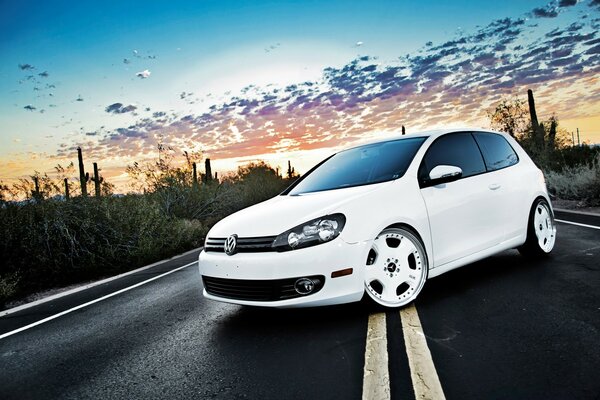 White Volkswagen car on the asphalt