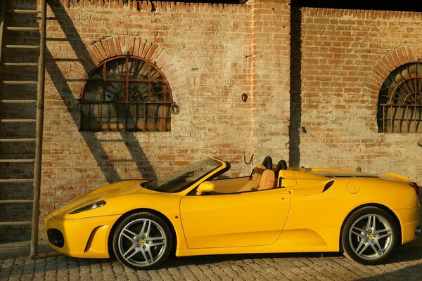 Yellow sports car near the house