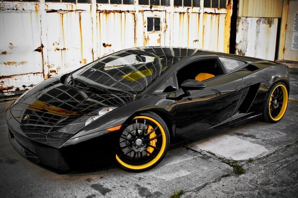 Black sports car with orange wheels