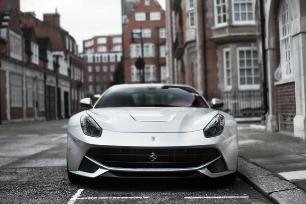 A beautiful silver car is standing on the street