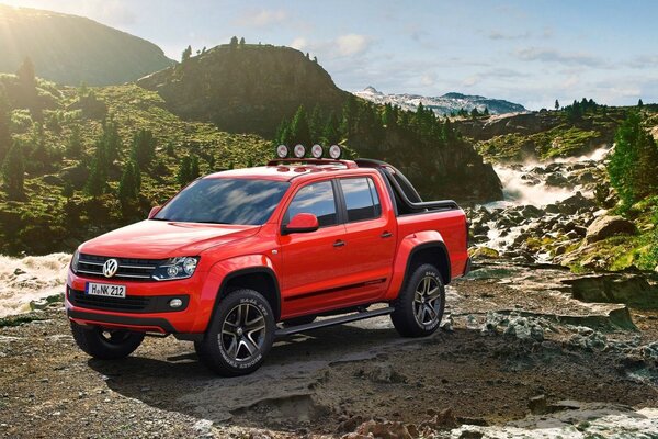 Red SUV in the mountains in the sun