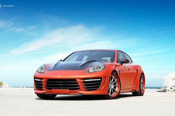 Orange porsche on the beach