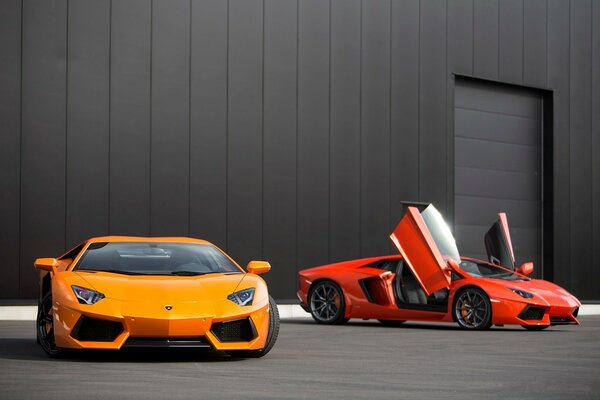 Two racing cars at the black building