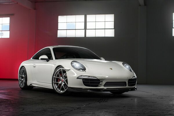 A white Porsche is in the garage